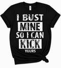 Black sports slogan tee reading I Bust Mine So I Can Kick Yours